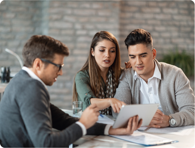 young-couple-using-touchpad-with-insurance-agent-while-making-loan-repayment-plan-during-meeting 1